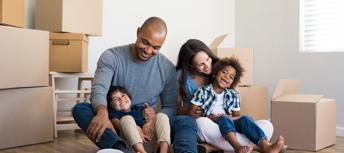 Happy family smiling in new home