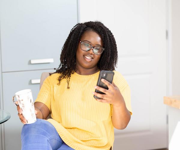 Woman In Kitchen On Phone