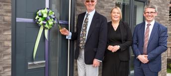 Photograph of colleagues cutting ribbon at Edgefield Green event