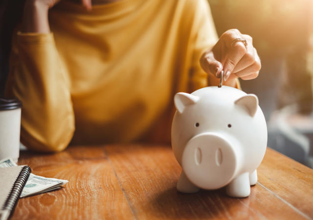 Putting Money In Piggy Bank
