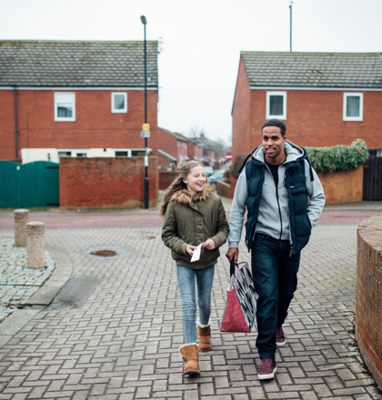 Male adult and child walking together